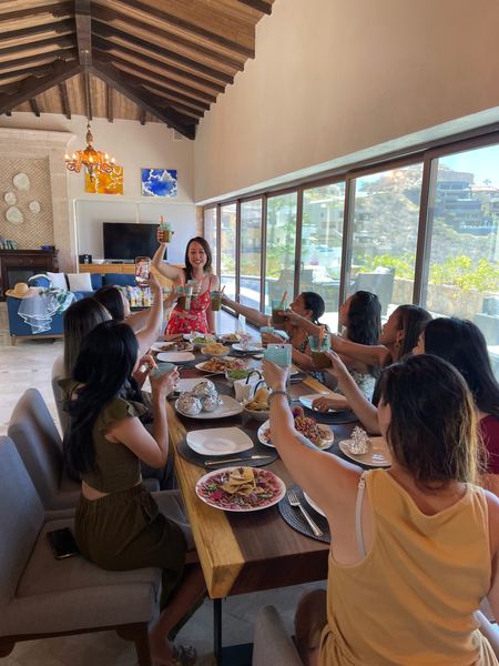 Guests raising their glasses around a long table in a Los Cabos villa